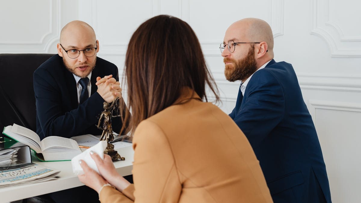 Professional discussion among lawyers in a modern office, focusing on legal matters.